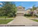 This two-story house with a well-maintained lawn is situated on a quiet street with a large, clean driveway at 6961 King Creek Dr, Sun City Center, FL 33573