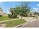 This well-manicured two-story home features a lush green lawn and a driveway with multiple cars in a suburban neighborhood at 6961 King Creek Dr, Sun City Center, FL 33573