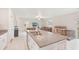 Open-concept kitchen featuring an island with seating and stainless steel sink at 6961 King Creek Dr, Sun City Center, FL 33573
