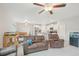 Bright living room featuring tile floors, ceiling fans, and an open floor plan at 6961 King Creek Dr, Sun City Center, FL 33573