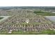 A real estate map marker hovers over a well-planned community of single Gathering homes in an aerial shot with nearby lakes at 6961 King Creek Dr, Sun City Center, FL 33573