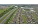 Aerial image showcasing a residential neighborhood bordering a highway and scenic lakes, surrounded by lush greenery at 6961 King Creek Dr, Sun City Center, FL 33573