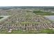 An aerial photograph shows a sprawling neighborhood with lake views and rows of single-Gathering homes with consistent landscaping at 6961 King Creek Dr, Sun City Center, FL 33573