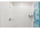Close-up of the tiled shower with a shower head and a patterned curtain at 6961 King Creek Dr, Sun City Center, FL 33573