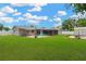 Large, well-maintained backyard with a brick patio, screened porch, and ample green space for outdoor enjoyment at 704 Childers Loop, Brandon, FL 33511