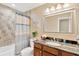 Updated bathroom features a granite countertop, wooden vanity, and tiled shower with stylish shower curtain at 704 Childers Loop, Brandon, FL 33511