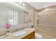 Updated bathroom with granite countertop, decorative mirror, and tiled shower at 704 Childers Loop, Brandon, FL 33511
