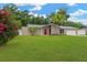 Lovely single-story house featuring a bright red door, stone detailing, and mature landscaping at 704 Childers Loop, Brandon, FL 33511