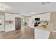 Bright, modern kitchen with white cabinets, stainless appliances, and view to a backyard pool at 704 Childers Loop, Brandon, FL 33511