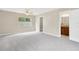 Spacious main bedroom featuring plush carpet, a ceiling fan, and an ensuite bathroom at 704 Childers Loop, Brandon, FL 33511