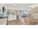 Bright open-concept living space with wood floors, modern kitchen, and ample natural light at 704 Childers Loop, Brandon, FL 33511