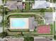 Aerial view showcasing community pool, clubhouse, and sports court amidst homes at 7611 Wood Violet Dr, Gibsonton, FL 33534