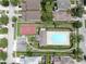 Overhead aerial view displaying community pool and basketball court amidst residential houses at 7611 Wood Violet Dr, Gibsonton, FL 33534