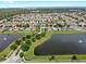 Aerial view of a community with lakefront homes, pool, landscaping, and a serene environment at 7611 Wood Violet Dr, Gibsonton, FL 33534