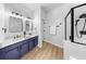 Stylish bathroom featuring double sinks, modern fixtures, and a sleek walk-in shower with black hardware at 7611 Wood Violet Dr, Gibsonton, FL 33534