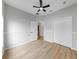 A bright bedroom with wood floors, neutral walls, and a ceiling fan at 7611 Wood Violet Dr, Gibsonton, FL 33534