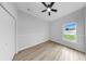 Bright bedroom featuring wood floors, neutral walls, and ample natural light at 7611 Wood Violet Dr, Gibsonton, FL 33534