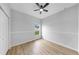 Bright bedroom featuring wood floors, neutral walls, and ample natural light at 7611 Wood Violet Dr, Gibsonton, FL 33534