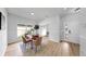 Bright dining area features a wooden table, modern chairs, and natural light from a nearby window at 7611 Wood Violet Dr, Gibsonton, FL 33534