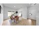 Bright dining area features a wooden table, modern chairs, and natural light from a nearby window at 7611 Wood Violet Dr, Gibsonton, FL 33534