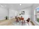 Stylish dining area with a wooden table, modern chairs, and bright natural light at 7611 Wood Violet Dr, Gibsonton, FL 33534