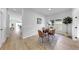 Stylish dining area with a wooden table, modern chairs, and bright natural light at 7611 Wood Violet Dr, Gibsonton, FL 33534
