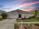 Charming single-story home with a well-maintained lawn, fresh landscaping, and a two-car garage at 7611 Wood Violet Dr, Gibsonton, FL 33534