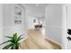 Hallway with hardwood floors leading to a dining area, showcasing an open and inviting layout at 7611 Wood Violet Dr, Gibsonton, FL 33534