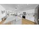 Bright kitchen with white cabinets, quartz countertops, and stainless steel appliances with an open layout at 7611 Wood Violet Dr, Gibsonton, FL 33534
