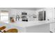 Bright, modern kitchen with white cabinetry and stainless steel appliances, including a microwave and oven at 7611 Wood Violet Dr, Gibsonton, FL 33534