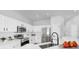 Modern kitchen with white cabinets, stainless steel appliances, and stylish faucet at 7611 Wood Violet Dr, Gibsonton, FL 33534