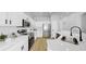 Modern kitchen featuring white cabinets, stainless steel appliances and tile backsplash at 7611 Wood Violet Dr, Gibsonton, FL 33534