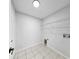 Functional laundry room with tile flooring and wire shelving for storage at 7611 Wood Violet Dr, Gibsonton, FL 33534