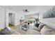 A bright living room features neutral decor, natural light, and sliding doors to the backyard at 7611 Wood Violet Dr, Gibsonton, FL 33534