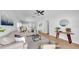 Open-concept living room with kitchen view, neutral palette, and ample natural light at 7611 Wood Violet Dr, Gibsonton, FL 33534