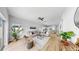 Spacious living room with bright, neutral decor, wood flooring and a view to the modern kitchen at 7611 Wood Violet Dr, Gibsonton, FL 33534