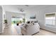 Bright living room featuring hardwood floors, neutral paint, and sliding door access to the backyard at 7611 Wood Violet Dr, Gibsonton, FL 33534