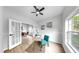 Bright home office with hardwood floors, a modern desk, French doors, and comfortable seating at 7611 Wood Violet Dr, Gibsonton, FL 33534