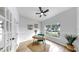 Well-lit home office featuring hardwood floors, a modern desk, comfortable chair, and a view to the exterior at 7611 Wood Violet Dr, Gibsonton, FL 33534