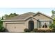 Charming one-story home featuring a neutral color scheme and an attached two-car garage at 7696 Wheat Stone Dr, Zephyrhills, FL 33540
