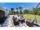 The spacious backyard patio has seating around a fire pit, perfect for outdoor entertaining at 7815 16Th Nw Ave, Bradenton, FL 34209