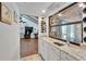 Bar area with granite countertops, a wine rack, glass storage, and a picturesque view of the backyard at 7815 16Th Nw Ave, Bradenton, FL 34209