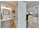 View from doorway of a bathroom with a modern vanity and a kitchen beyond at 7815 16Th Nw Ave, Bradenton, FL 34209