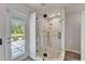 Well-lit bathroom with a glass shower enclosure and direct access to the outdoor area with pool at 7815 16Th Nw Ave, Bradenton, FL 34209