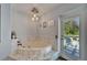 Stylish bathtub with marble detailing, complemented by decorative lighting fixtures and backyard views at 7815 16Th Nw Ave, Bradenton, FL 34209