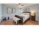 Comfortable bedroom with wood floors and ceiling fan is nicely decorated and well lit at 7815 16Th Nw Ave, Bradenton, FL 34209