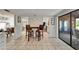 Light filled dining area with tile floors and views into the bar area and screened-in patio at 7815 16Th Nw Ave, Bradenton, FL 34209