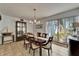 Bright dining room with tile flooring, modern chandelier, and natural light from the large window at 7815 16Th Nw Ave, Bradenton, FL 34209