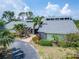 Stunning home featuring beautiful landscaping, a brick walkway, and a striking blue double door entry at 7815 16Th Nw Ave, Bradenton, FL 34209