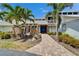 Inviting home with a brick path leading to a striking blue double door, complemented by stone accents at 7815 16Th Nw Ave, Bradenton, FL 34209